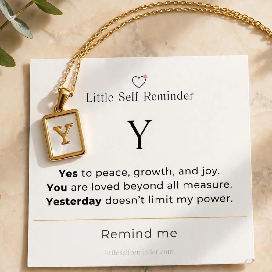 A gold chain necklace with a square pendant displaying the letter 'Y' in gold on a white inlay, presented on a white card that reads 'Little Self Reminder'.