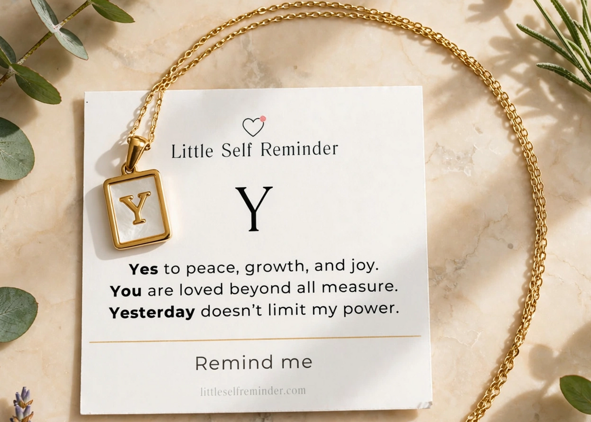A gold chain necklace with a square pendant displaying the letter 'Y' in gold on a white inlay, presented on a white card that reads 'Little Self Reminder'.